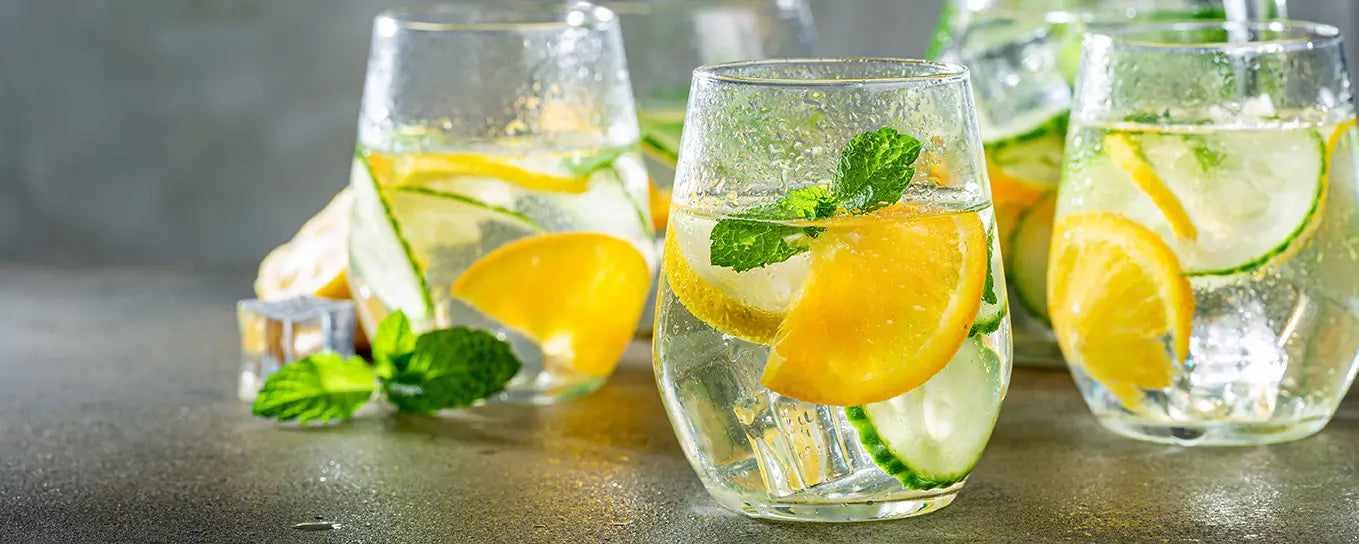 glasses of water with citrus fruits
