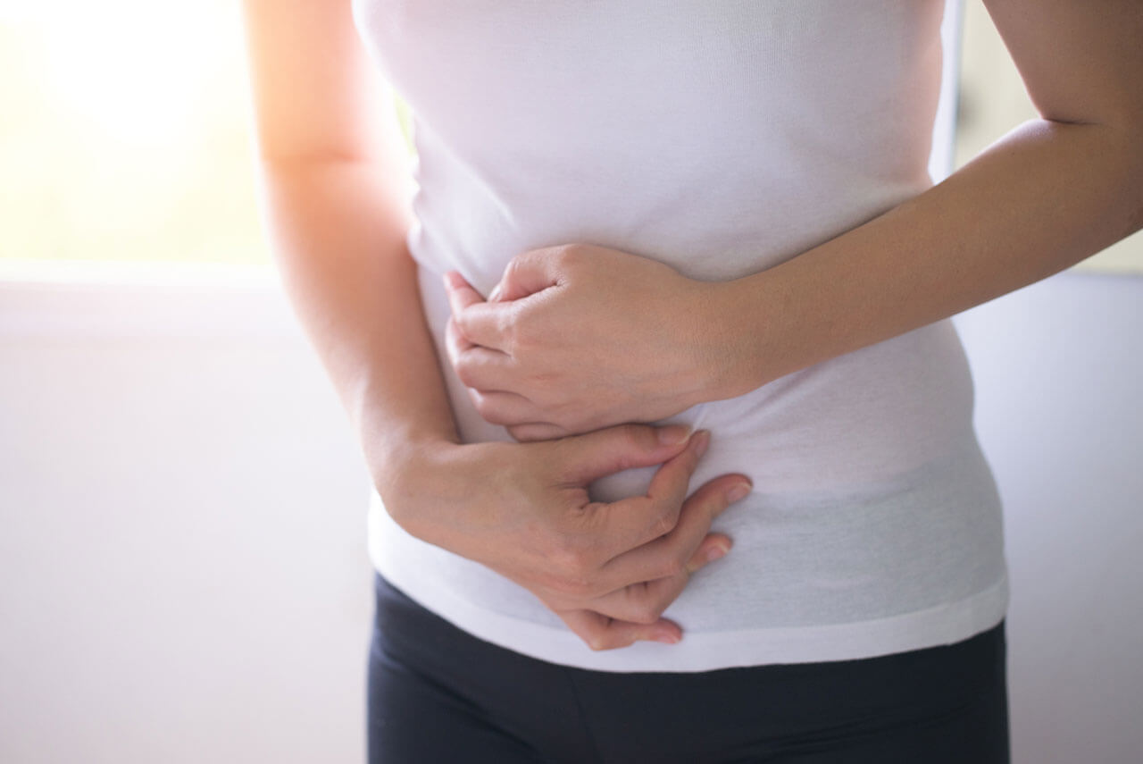 woman holding her upset stomach