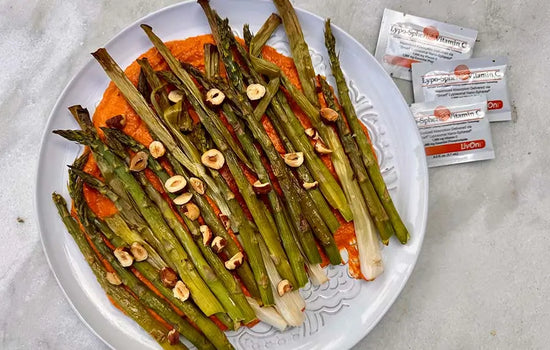 overhead photo of spring vegetables dish with packets of lypo-spheric vitamin c