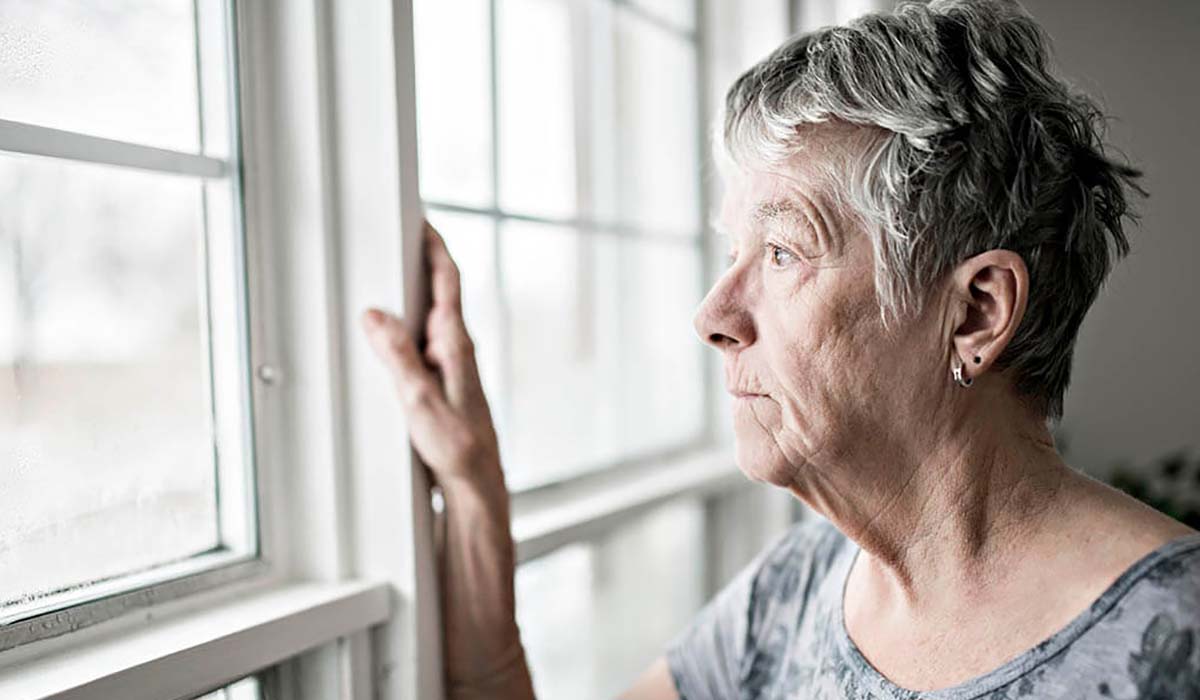 elderly woman staring out window