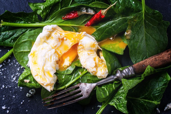 fried egg on spinach contains many of the b complex benefits
