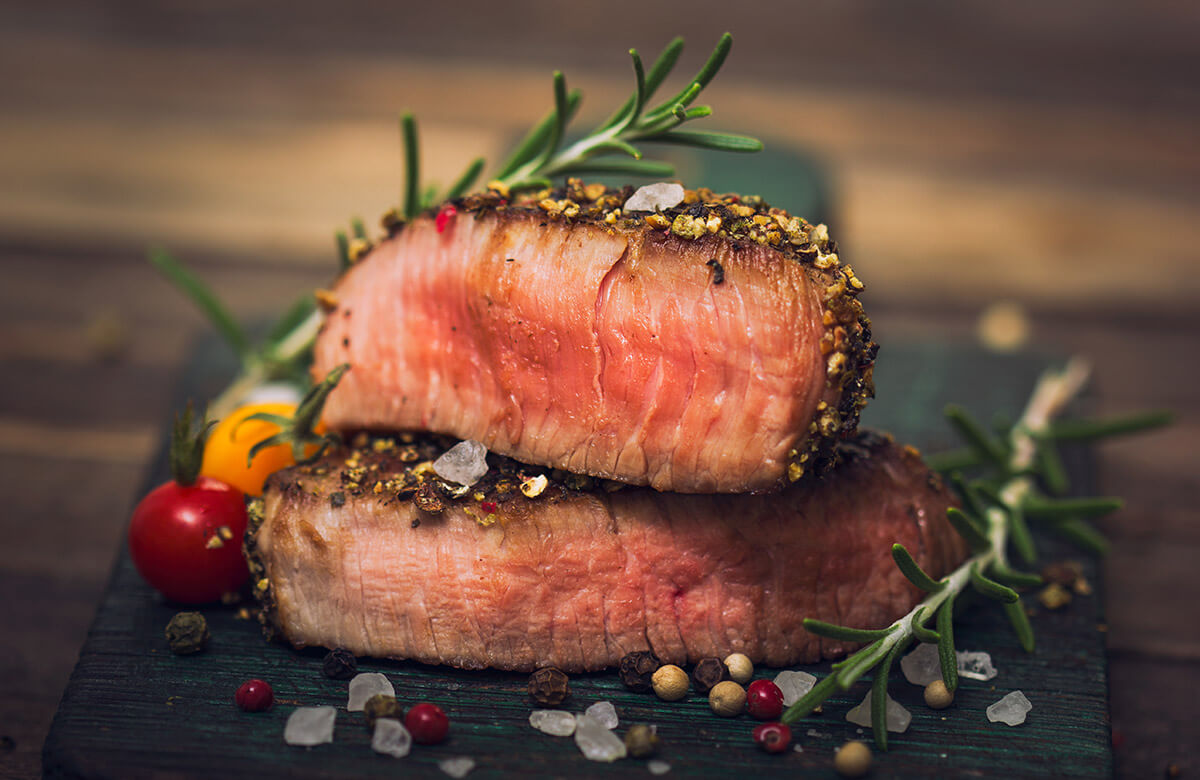 black pepper crusted steak sliced in half illustrates one of the powerful vitamin combinations