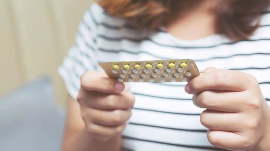 Woman hands opening birth control pills