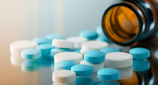 Bottle with pills spilling onto table