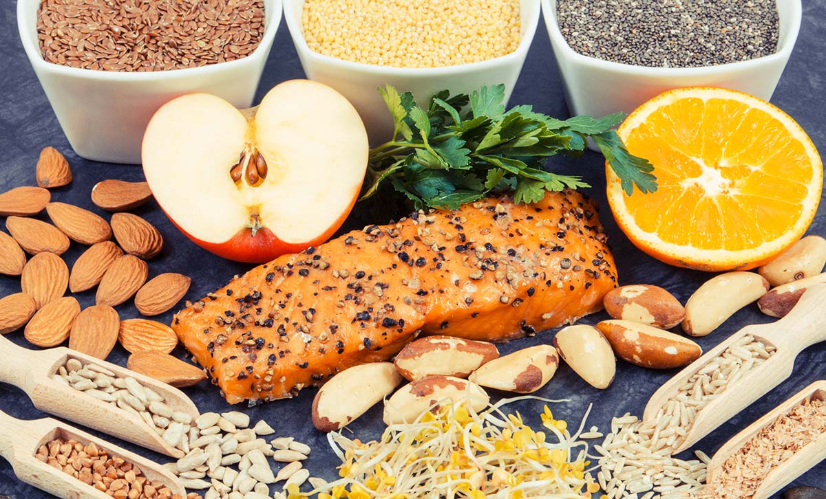 photo of salmon, nuts, fruits, and seeds containing thyroid nutrients