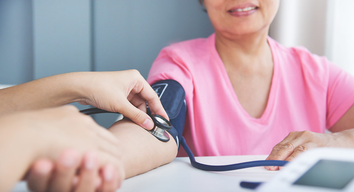 woman getting blood pressure measured