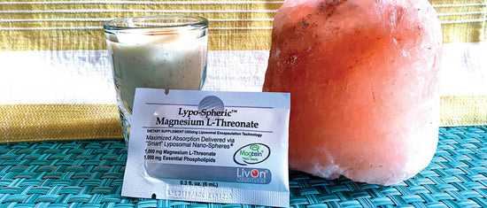 shot of the nightcap with packet of lypospheric magnesium l-threonate and a Himalayan salt lamp