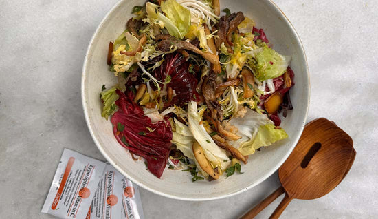 warm mushroom salad in bowl with packets of lypo-spheric vitamin c