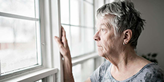 older woman looking out a window