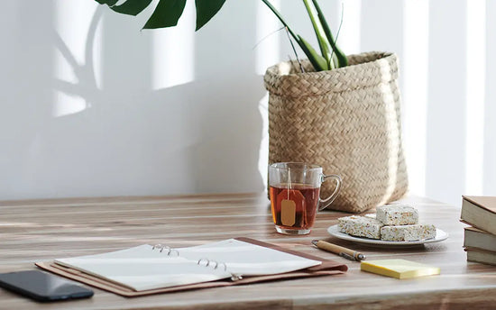 gratitude journal on desk with tea and a plant