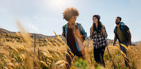 Group of friends hiking outdoors for better health and happiness