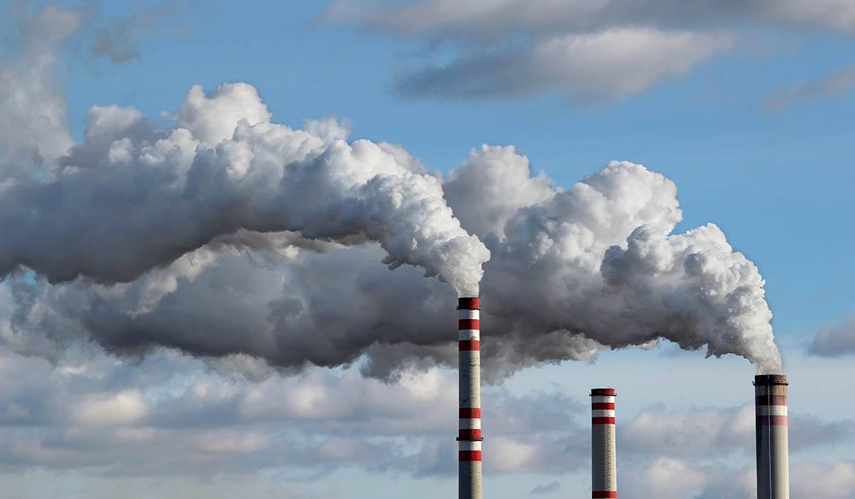 factory smoke stacks release air pollution that can cause free radicals