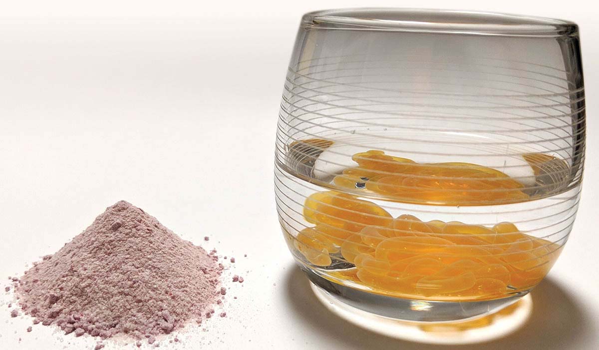 pile of vitamin c powder on the left and glass of water with lypo-spheric vitamin c on the right