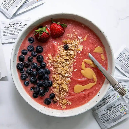 smoothie bowl with granola, berries, and drizzle of lypo-spheric magnesium